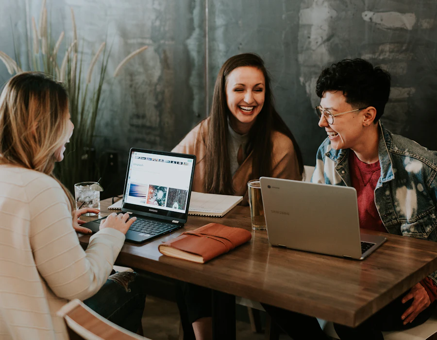 Três jovens trabalhando juntos com notebooks